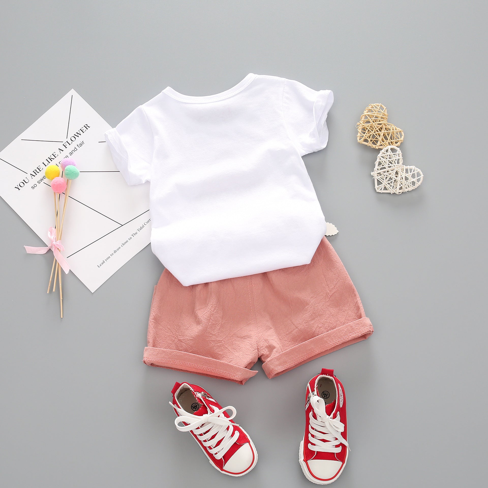 “Child wearing Girls Summer Short Sleeve Suit outdoors on a sunny day”