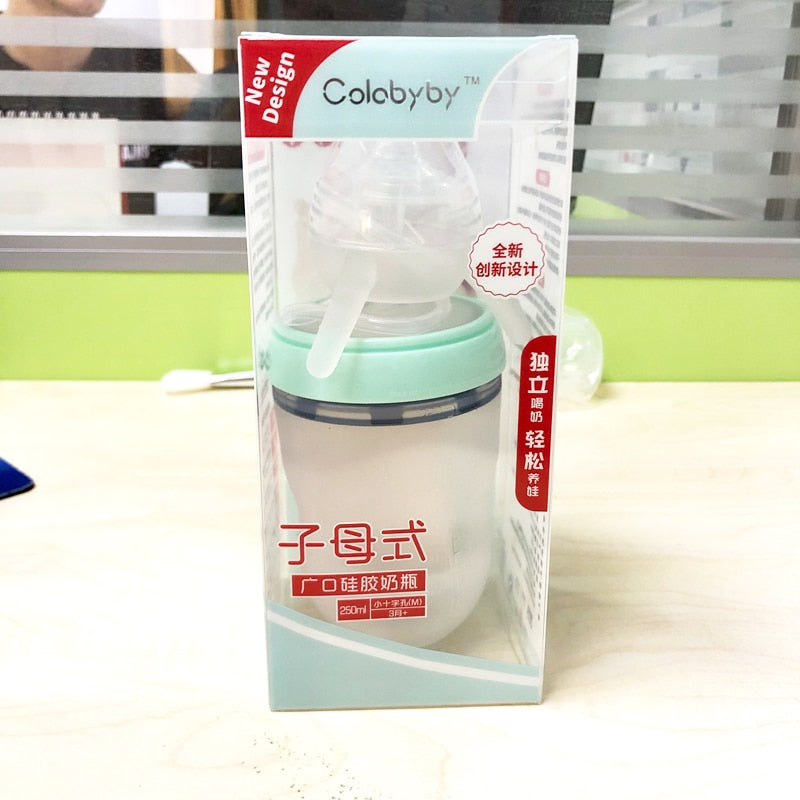 Toddler drinking from Hands-Free Baby Bottle independently