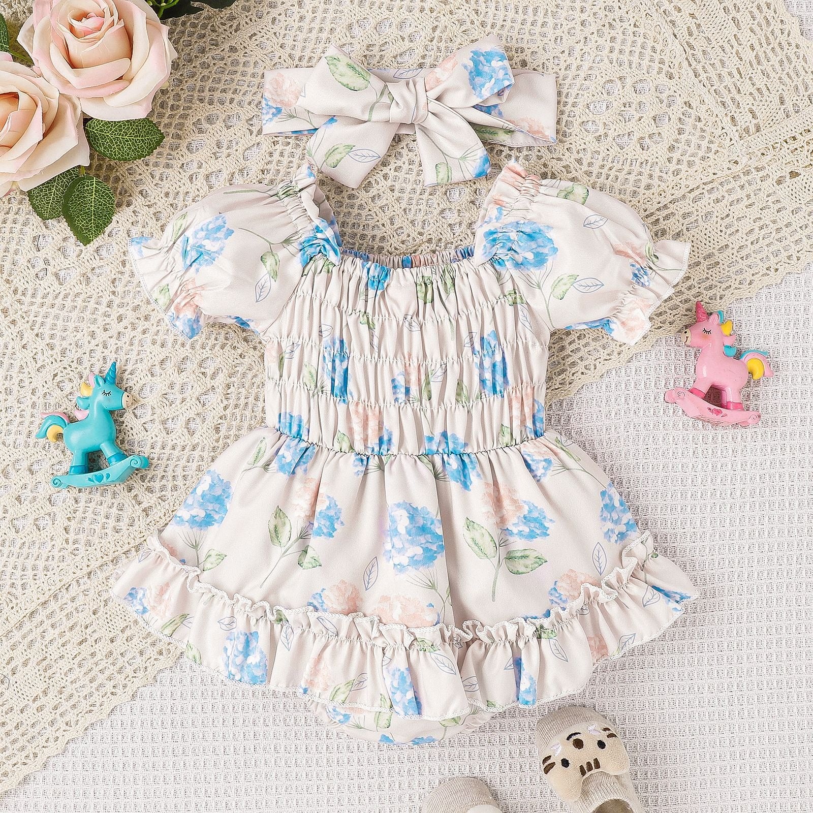 "Front view of Baby and Toddler Two Color Floral Skirt Hem Jumpsuit showing skirt hem"