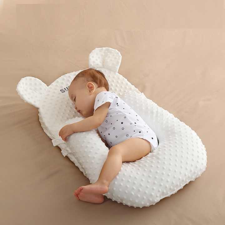 "Baby using Four Season Anti Milk Overflow and Choking Pillow Baby Feeding Tool Baby Anti Spitting Slope Pad during feeding"