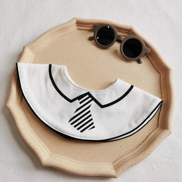 “Baby wearing Baby Boy Bib with bow tie, staying clean during mealtime”