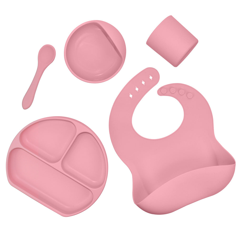 Happy Toddler Using Baby Feeding Bowl and Spoon Set at Mealtime