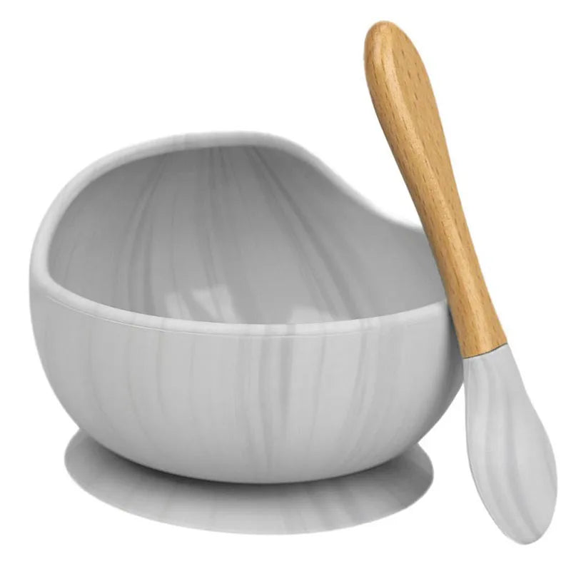 Parent using Baby Silicone Tableware to feed toddler safely